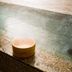 Super Hotel Inn Sendai Kokubuncho hot spring bath with stone edge and wooden bath bucket in Sendai