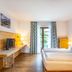 Das Bergmayr - Chiemgauer Alpenhotel in Inzell, cozy guest room with double bed and balcony doors