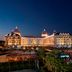 Adalya Elite Lara Hotel in Antalya at night with illuminated facade and outdoor pools
