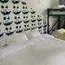 Hostel Fish in Denver dorm room with bunk beds, patterned wall art, and a window