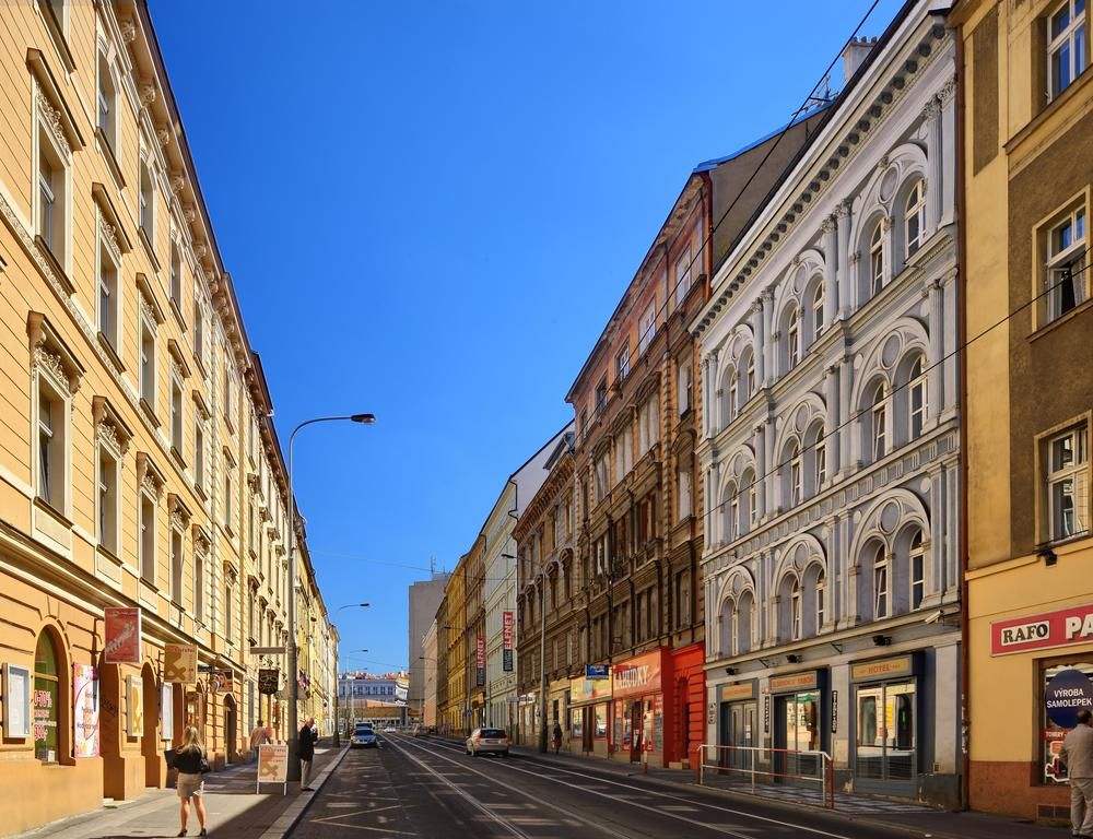Residence Tabor in Prague on a city street lined with historic buildings under a clear blue sky