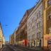 Residence Tabor in Prague on a city street lined with historic buildings under a clear blue sky