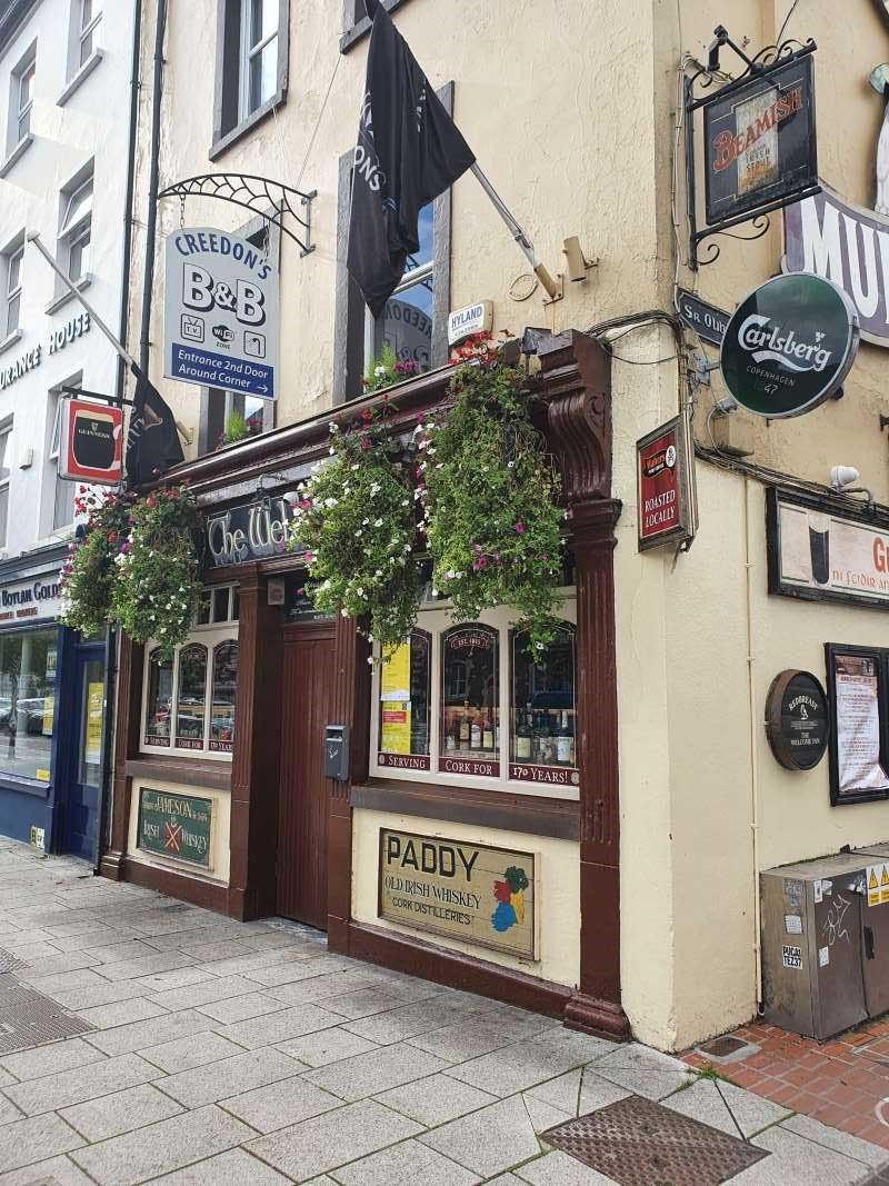 Creedons Traditional Welcome Accommodation in Cork exterior with hanging flower baskets and pub-style storefront