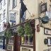 Creedons Traditional Welcome Accommodation in Cork exterior with hanging flower baskets and pub-style storefront