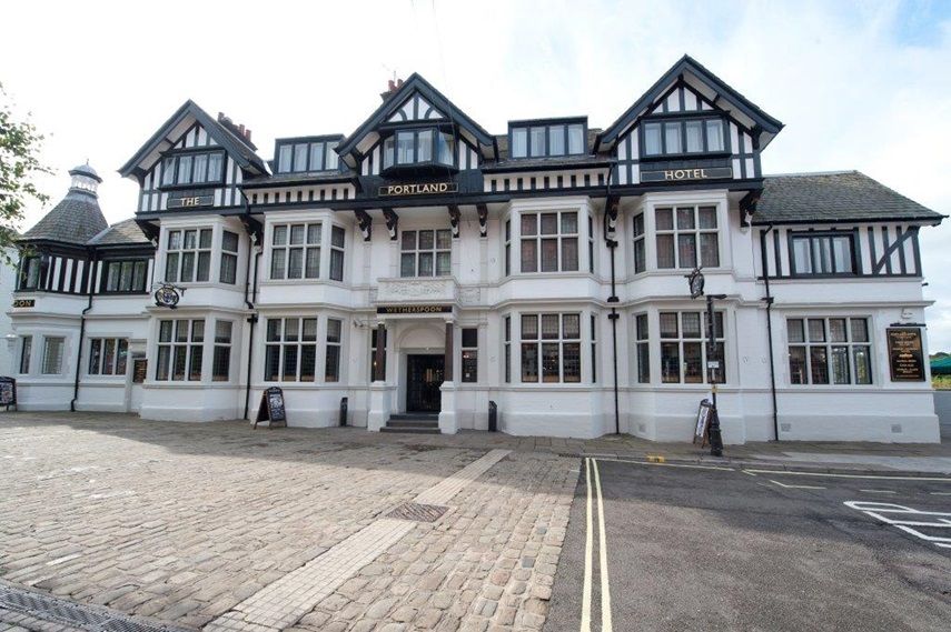 The Portland Hotel in Chesterfield, exterior view of a white Tudor-style hotel building