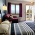 Square Rigger Lodge in Egg Harbor guest room with balcony door, lake view, sofa, and two beds