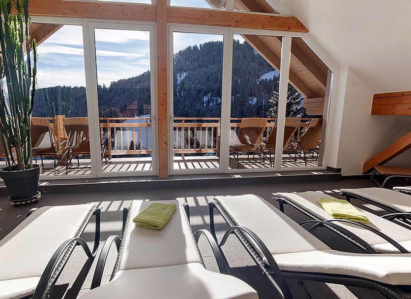 Natuerlich in Fiss lounge chairs facing a balcony with mountain and forest views