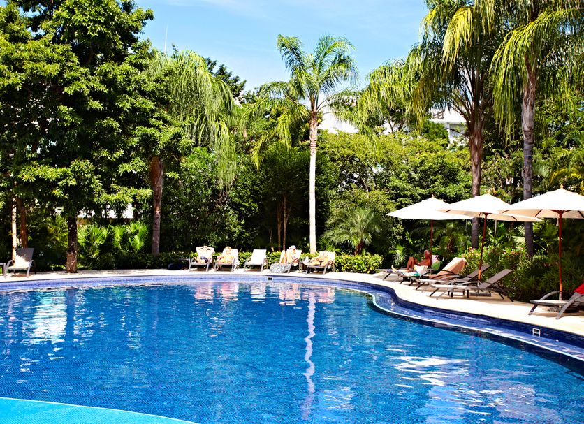 Bahia Principe Escape Sian Ka'an - Adults Only pool surrounded by palm trees in Akumal