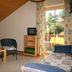 Pension Hoisl in Schönberg: cozy room with twin beds, TV, seating area and balcony door to garden