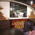 City Park Hotel, Chisinau lounge with tufted seating, exposed brick arches and wood stack decor