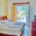 Venardos Hotel in Agia Pelagia bedroom with balcony door to terrace and sea view