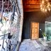 Hotel Grand Vista Cuernavaca entrance with wrought-iron gate, chandelier, and glass doorway in Cuernavaca