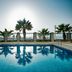 Mitsis La Vita in Rhodes with a palm-framed outdoor pool and sea view