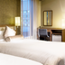 Koko Hotel Ginza-1chome in Tokyo guest room with two beds, desk, and large windows