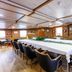 Botel Marina in Rijeka meeting room with long conference table, black chairs, and wood-paneled interior