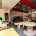 Botel Marina in Rijeka, colorful lounge with round table, bench seating and tent-like nook