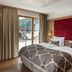 Schlosshotel Fiss guest room with king bed, balcony doors and mountain view in Fiss