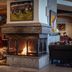 Schlosshotel Fiss in Fiss lounge with a stone fireplace and cozy seating area