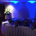 Buffet table with floral arrangements at 506 Little Harbor Inn in Ruskin under blue accent lighting