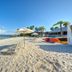 506 Little Harbor Inn in Ruskin with sandy beach, lounge chairs, umbrellas, and kayaks by the water
