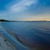506 Little Harbor Inn in Ruskin with a quiet sandy beach and calm waterfront at dusk