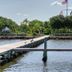 506 Little Harbor Inn in Ruskin with a waterfront dock, calm water, and American flag