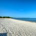 506 Little Harbor Inn in Ruskin with a sandy beach and calm blue water under a clear sky