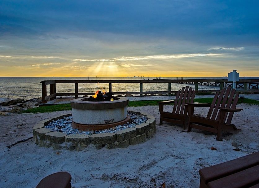 506 Little Harbor Inn in Ruskin with a seaside fire pit, Adirondack chairs and sunset ocean view