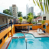 Cresta Inn in Panama City, rooftop-style pool with lounge chairs and city skyline views