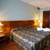 Zenit Diplomatic in Andorra la Vella guest room with double bed, desk, lamps and wood flooring