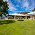 Ngapuke Farm Matamata in Matamata with a large green lawn, pool, and single-story lodge buildings