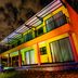 Grand View B&B in Johannesburg, colorful exterior hotel facade at night with balcony and lit entrance