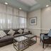 Princess Bayside Beach Hotel in Ocean City living room with sectional sofa, glass tables and blue armchair