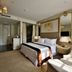 Hotel Royal Bogor room in Bogor with king bed, mirrored wall, chandelier, and seating area