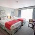 Harrison Lake Hotel room in Harrison Hot Springs with two double beds and a large window