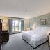 Harrison Lake Hotel guest room in Harrison Hot Springs with king bed, desk, and window view