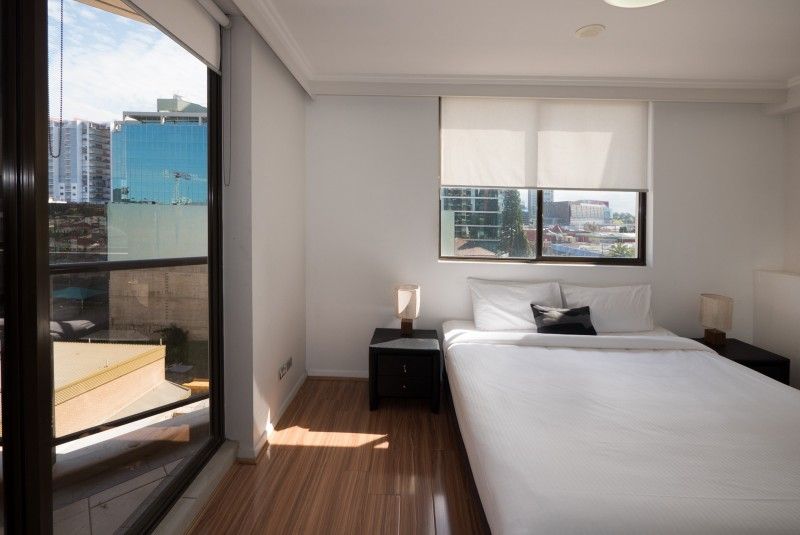 Fiori Apartments, Sydney bedroom with large window and city views