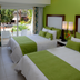 Cancun Bay Resort room in Cancún with two beds and a balcony view of the garden