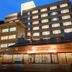 Ashinomaki Grand Hotel in Aizuwakamatsu at dusk, showing a multi-story exterior with lit windows