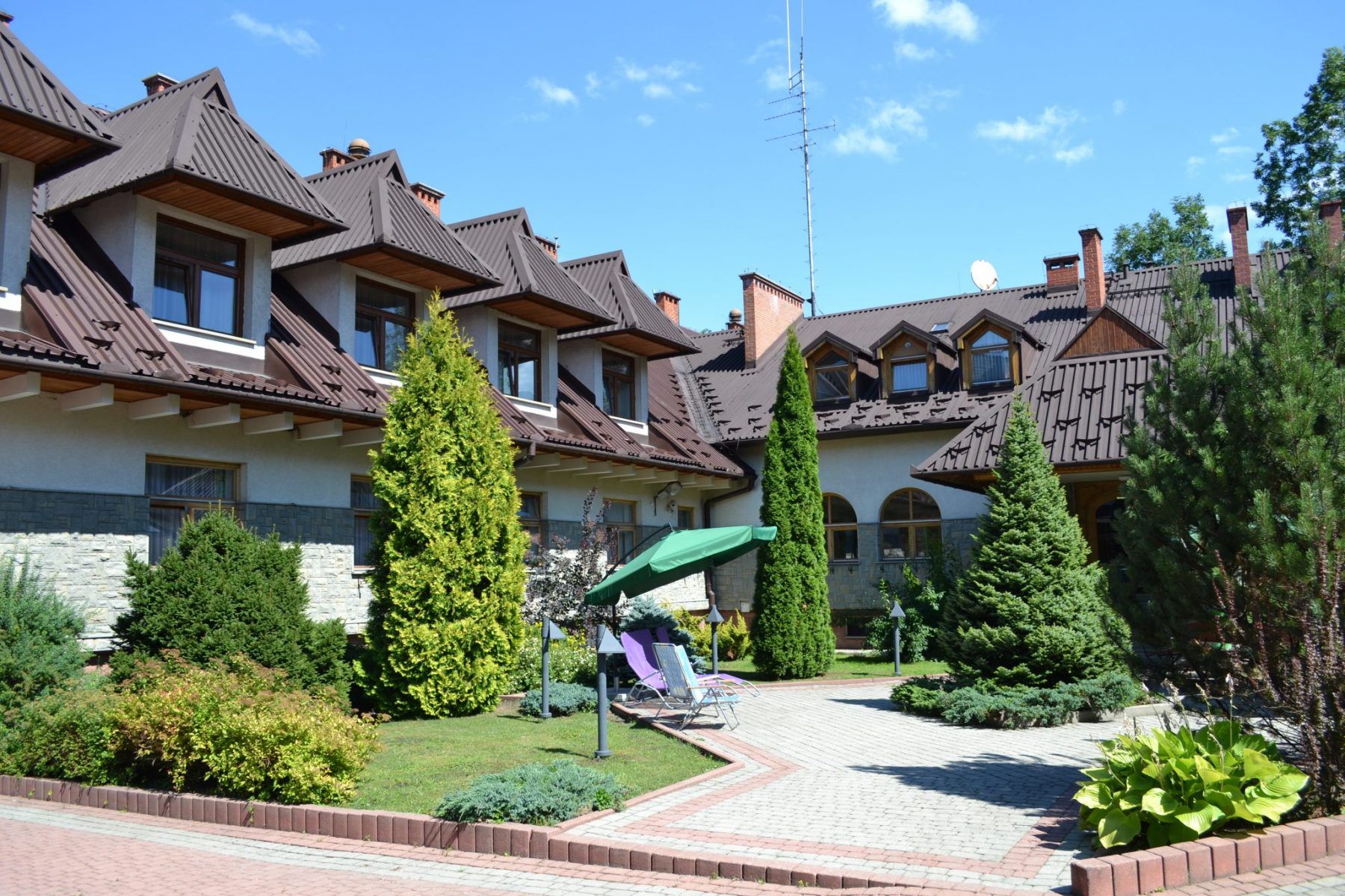 Okw Parzenica in Zakopane with chalet-style building, landscaped garden, and stone pathway