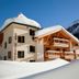 Der Waldhof in Sankt Anton am Arlberg, a snow-covered alpine hotel with wooden balconies and mountain backdrop