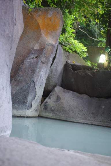 Kirishima Yunotani Sanso hot spring pool beside natural rock formations in Kirishima