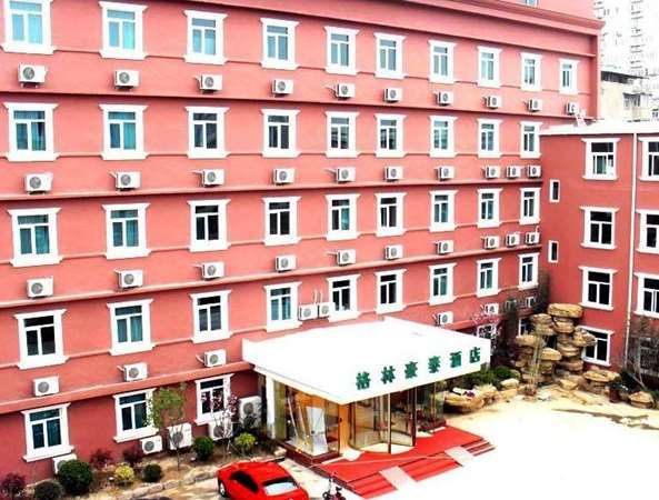 Greentree Inn Xuzhou North Minzhu Road Hotel exterior in Xuzhou, pink multi-story building with entrance