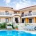 Stamos Hotel in Afytos with outdoor pool, sun loungers, and two-story balconies