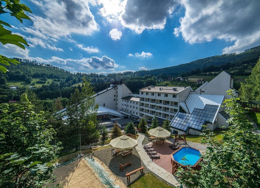Hotel Klimczok Resort&Spa in Szczyrk with outdoor pool, sun loungers, and mountain views