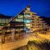 Hotel Klimczok Resort&Spa in Szczyrk at night, with a modern glass entrance and stepped balconies