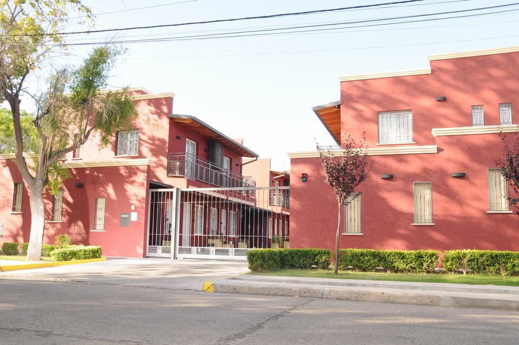 Complejo Mi Sueño in San Rafael with red stucco buildings and a gated entrance