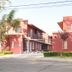 Complejo Mi Sueño in San Rafael with red stucco buildings and a gated entrance