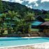 Hotel da Inês in Visconde de Maua with pool, tropical trees, and hillside backdrop