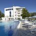 Hotel Firenze in Bibione with outdoor pool, sun loungers, and a white hotel building under a clear sky